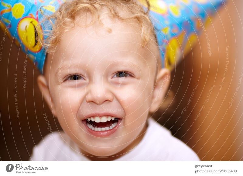 Closeup facial portrait of a happy laughing little boy with wavy blond hair looking directly into the camera Joy Happy Summer Feasts & Celebrations Birthday