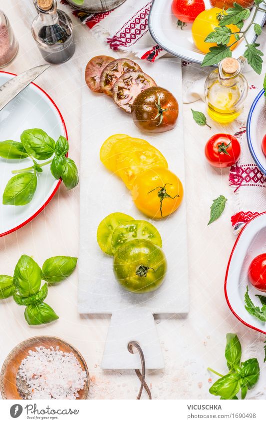 Green, yellow and red tomatoes on marble chopping board Food Vegetable Lettuce Salad Herbs and spices Cooking oil Nutrition Lunch Dinner Buffet Brunch