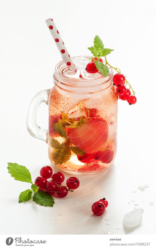 A glass of cool delicious soft drink with strawberry and currant on white background Beverage Redcurrant Strawberry Cold drink Lemonade Fruit Drinking water