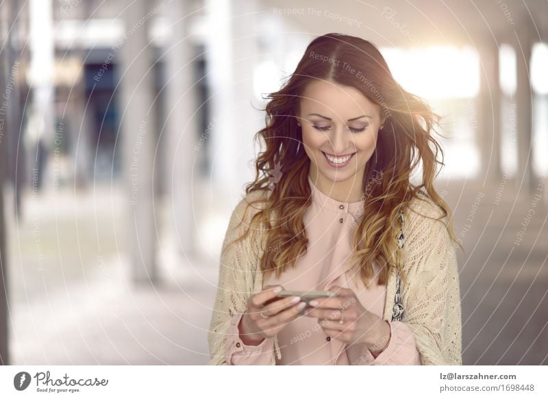 Young woman texting on her mobile phone Lifestyle Beautiful Reading Vacation & Travel Telephone PDA Technology Feminine Woman Adults 1 Human being 18 - 30 years