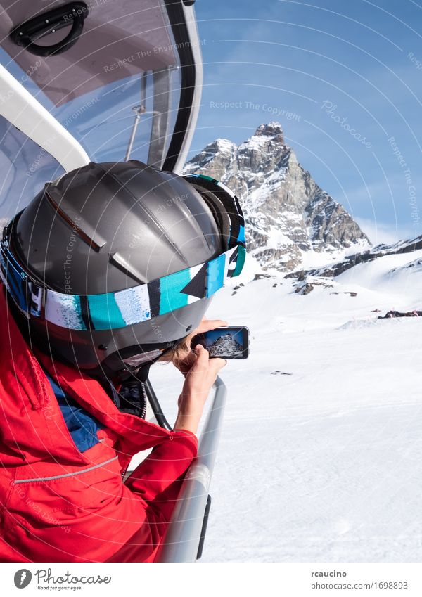 A young boy takes a photo of the Matterhorn Lifestyle Beautiful Vacation & Travel Tourism Winter Snow Mountain Sports Skiing Child PDA Camera Human being