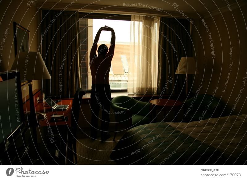 early riser in a hotel room Colour photo Interior shot Neutral Background Morning Shadow Back-light Rear view Forward Masculine Man Adults Arm 1 Human being