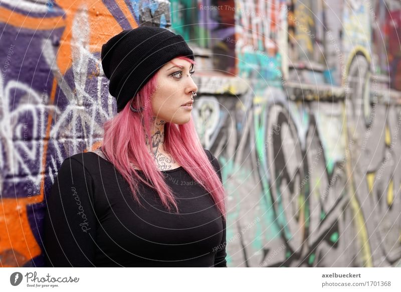 young woman leaning against graffiti wall Lifestyle Human being Feminine Young woman Youth (Young adults) Woman Adults 1 18 - 30 years Youth culture Subculture