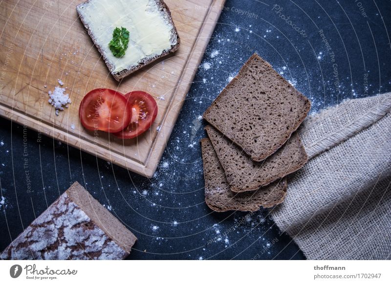 Enjoy a snack Sandwich Bütterken Bread Brunch Herbs and spices Flour butter knife Knives Chopping board Wood Wooden board Subsoil Dark Studio shot Nutrition