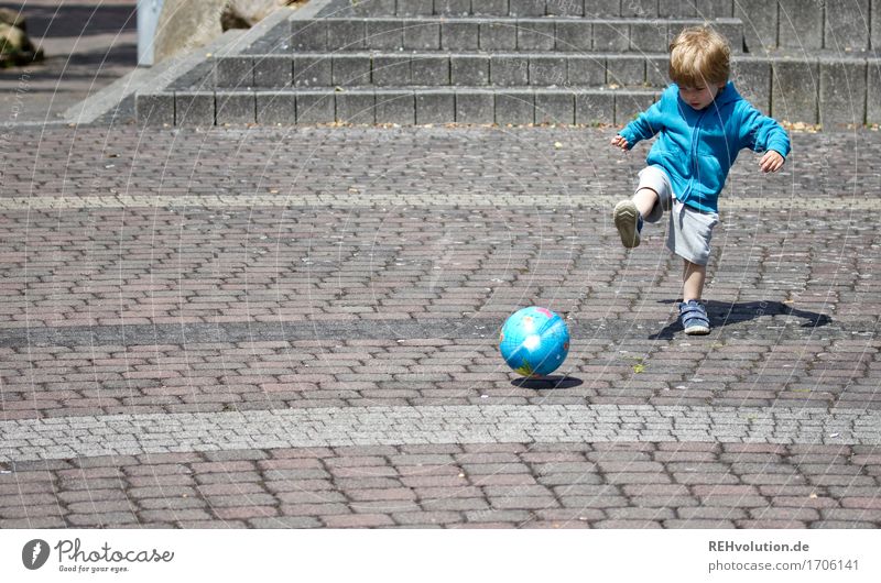 child plays soccer with a ball Sports Foot ball Human being Masculine Child Toddler Boy (child) 1 1 - 3 years Places Movement Playing Small Cute Athletic Blue