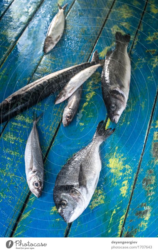 Wash fish. Sea bream, sea bass, mackerel and sardines Seafood Lunch Pan Fresh Blue Black wash watter see bass Lemon Raw cooking background healthy Frying Fat