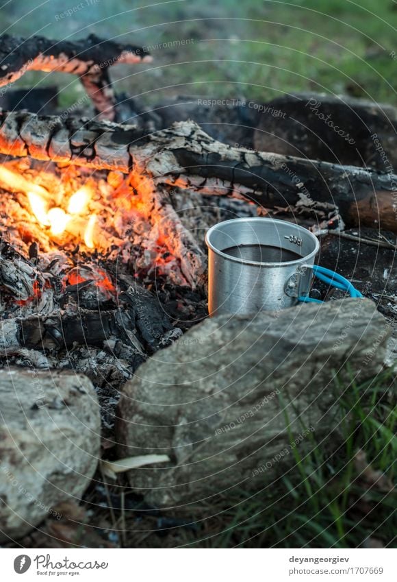 Camp fire and the black kettle of coffee