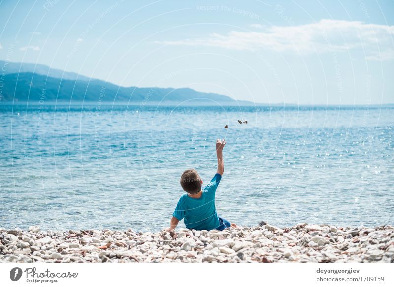 Children throw stones at the wate Lifestyle Beautiful Leisure and hobbies Playing Vacation & Travel Summer Beach Ocean Human being Girl Boy (child) Infancy