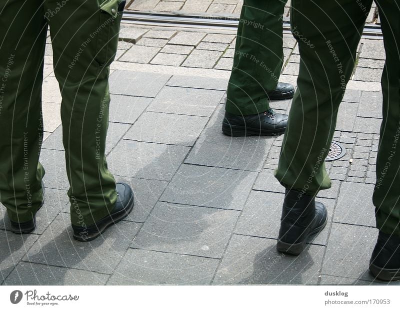 police Colour photo Exterior shot Downward Human being Legs Feet Workwear Work and employment Observe Fight Threat Police Force Protection Green Pants Guard
