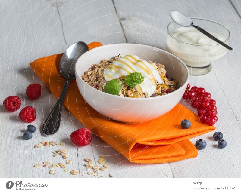 Muesli with yoghurt and fruits on wood Yoghurt Fruit Breakfast Wood Orange Cereal Cereals fruit muesli Oat flakes Honey raspberry Redcurrant Blueberry Mint
