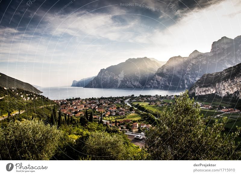 View of Lake Garda with the town of Turbel in the foreground Wide angle Long shot Central perspective Deep depth of field Sunset Sunrise Sunbeam Sunlight