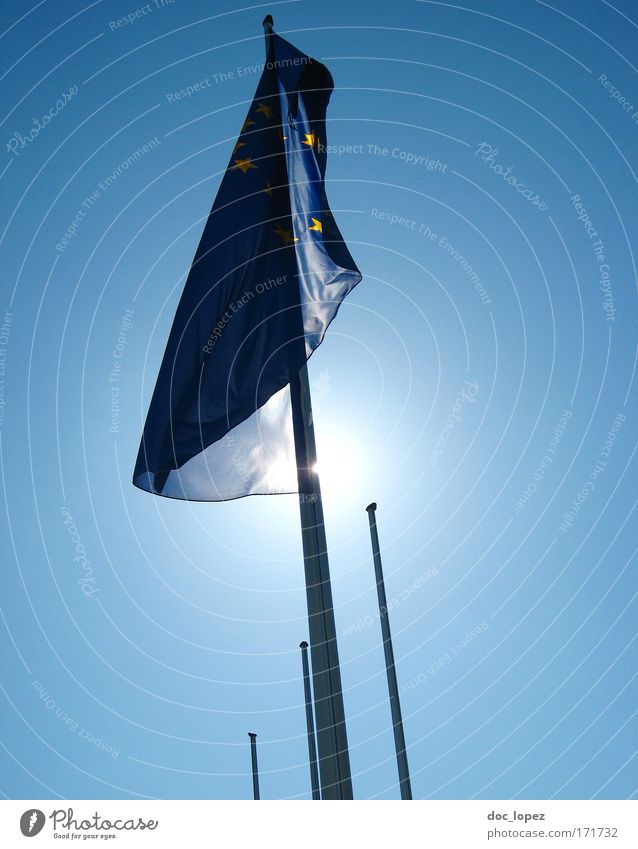 flagged & silhouetted Colour photo Exterior shot Day Light Silhouette Sunlight Back-light "Flagpole Euro symbol Political movements Rotate To fall Flying