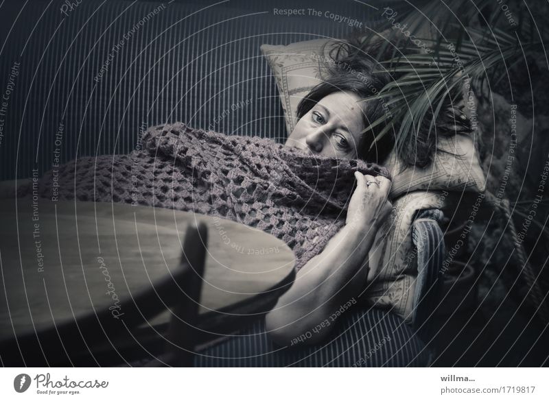 Woman lies dreamy melancholic on sofa, covered with crochet blanket Adults Relaxation Lie Dark Fatigue Sofa Palm frond Sadness Dream melancholy depression