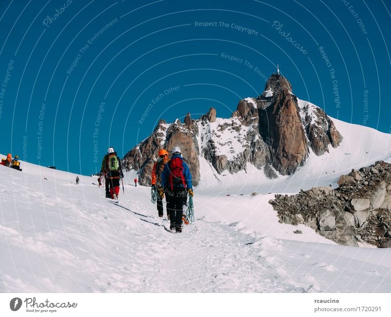 The Aiguille du Midi and a group of mountaineers. France Vacation & Travel Tourism Adventure Expedition Winter Snow Mountain Hiking Sports Climbing