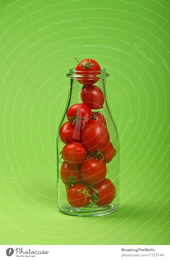 Juice or ketchup bottle full of red cherry tomatoes on green Food Vegetable Organic produce Vegetarian diet Diet Bottle Fresh Small Natural Original Green Red