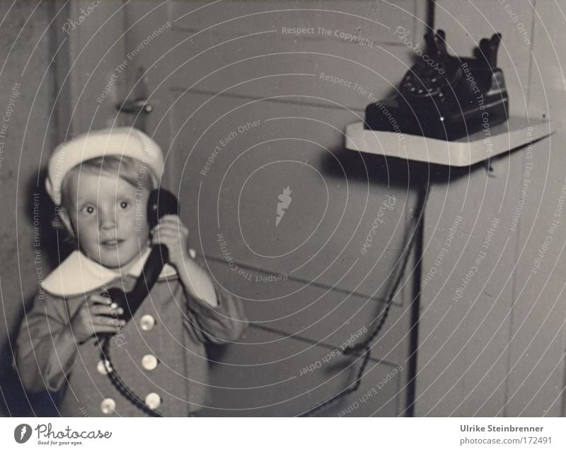 Little girl with beret on the phone Black & white photo Interior shot Copy Space right Flash photo Upper body Front view Forward Face Flat (apartment) Room