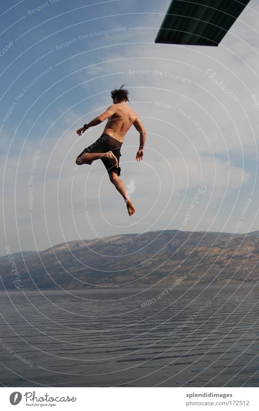 Jump into Lake Okanagan Colour photo Exterior shot Day Sunlight Deep depth of field Long shot Full-length Rear view Adventure Freedom Summer Summer vacation