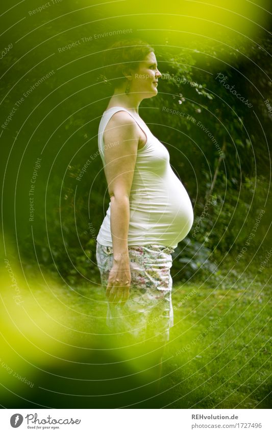 anticipation Human being Woman Adults Stomach 1 30 - 45 years Environment Nature Garden Park Skirt Brunette Short-haired Smiling Stand Pregnant Emotions Moody