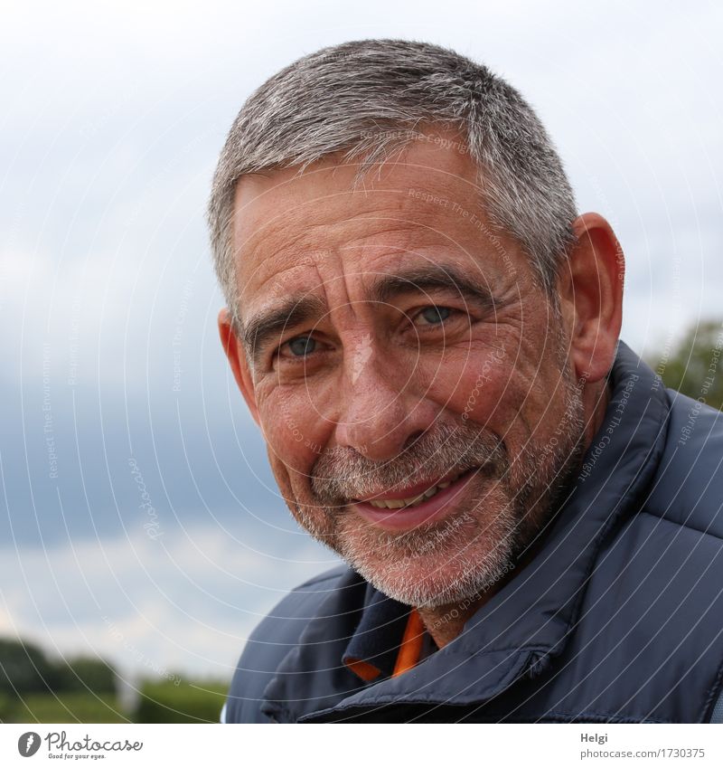 friendly senior with grey hair and grey beard smiles into the camera Human being Masculine Man Adults Male senior Senior citizen Head Face Facial hair 1