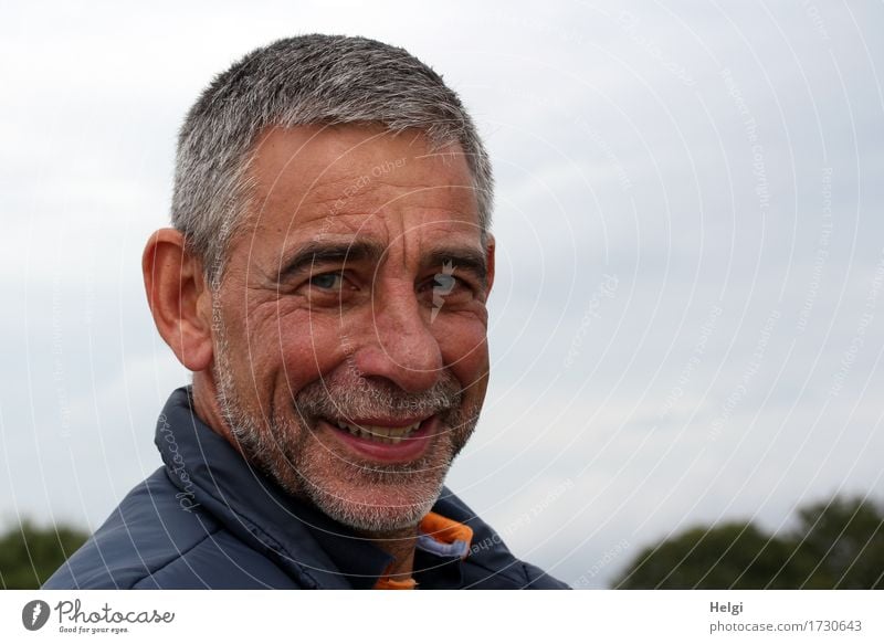 Portrait of a smiling senior with grey hair and grey beard in front of a grey sky Human being Masculine Man Adults Male senior Senior citizen Head Face