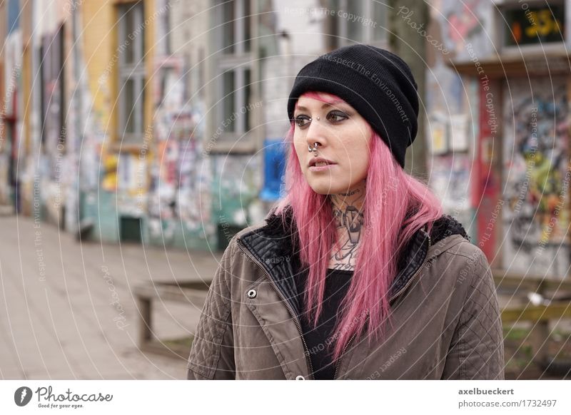 pierced and tattooed woman in front of graffiti covered building Lifestyle Unemployment Human being Young woman Youth (Young adults) Woman Adults 1
