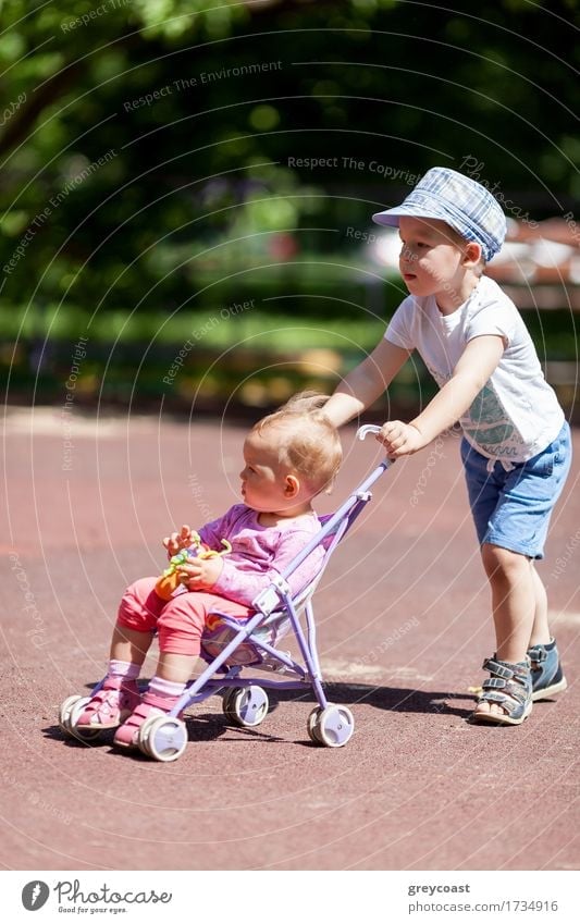 Young boy pushing little sister in a baby stroller Summer Garden Child Baby Girl Boy (child) Sister Family & Relations Infancy 2 Human being 1 - 3 years Toddler