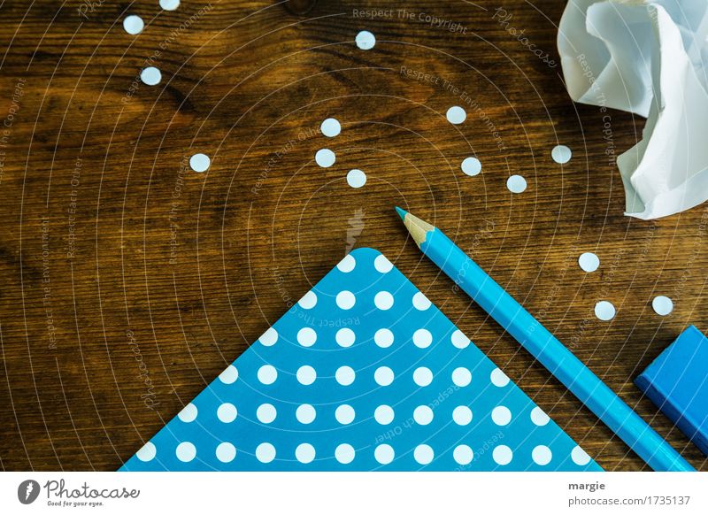 collect points: blue paper with white dots, pencil, eraser and a crumpled piece of paper on a wooden desk School Study Work and employment Profession
