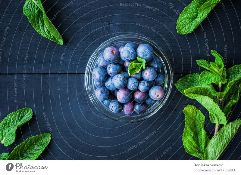 Blueberry with mint in a glass bowl Food Nutrition Vegetarian diet Table Wood Fresh Bright Green Colour background Berries cup Horizontal Ingredients many