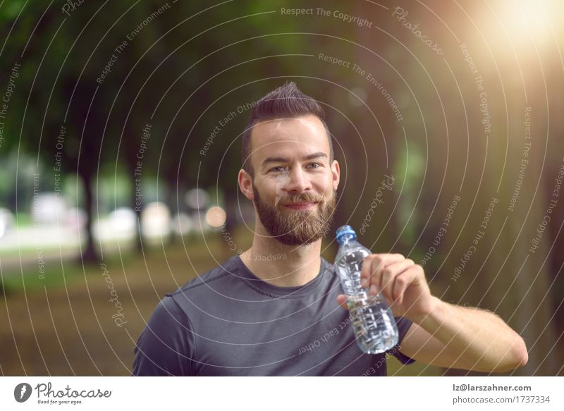 Young man drinking bottled water Drinking Lifestyle Face Summer Masculine Man Adults 1 Human being 18 - 30 years Youth (Young adults) Warmth Beard Fitness