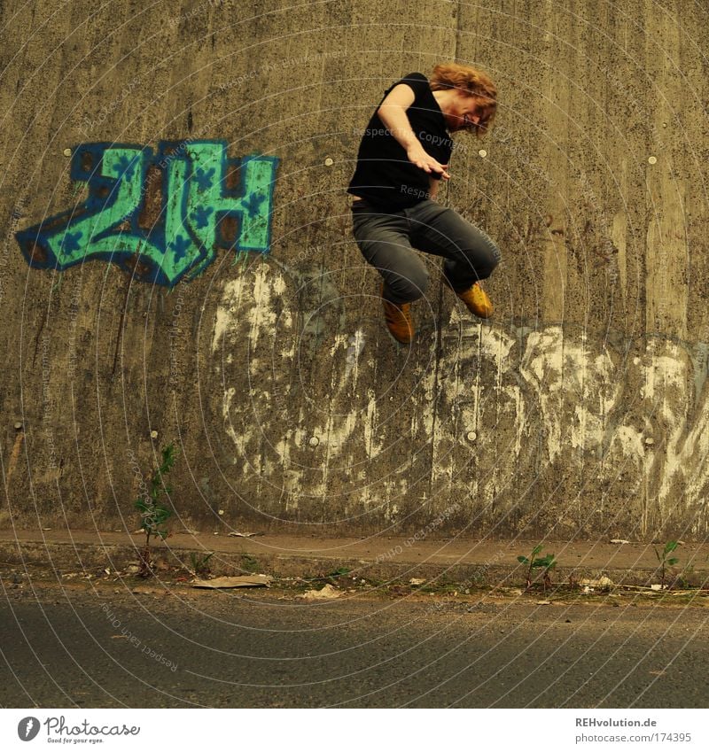 Young man jumps Colour photo Exterior shot Full-length Style Joy Human being Masculine Youth (Young adults) 1 18 - 30 years Adults Wall (barrier)