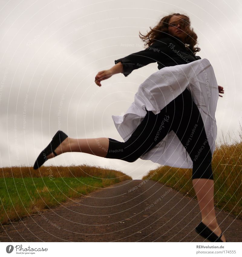 Woman jumps in a street Colour photo Exterior shot Full-length Joy Human being Feminine Young woman Youth (Young adults) 1 18 - 30 years Adults Landscape Meadow