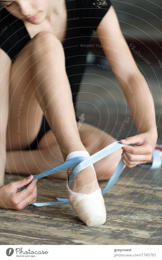 Girl with long legs tying her ballet shoes on the floor Elegant Beautiful Academic studies Human being 1 13 - 18 years Youth (Young adults) Dancer Ballet Tie