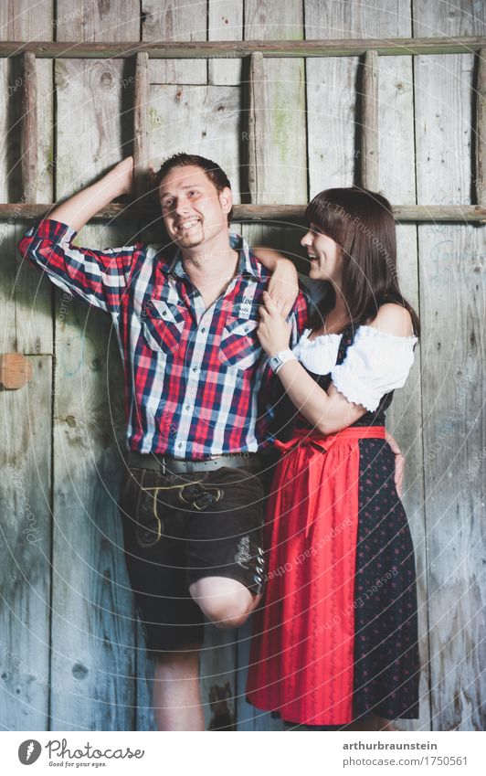 Young couple in traditional costume in front of a wooden hut Lifestyle Tourism House (Residential Structure) Oktoberfest Fairs & Carnivals Human being Masculine