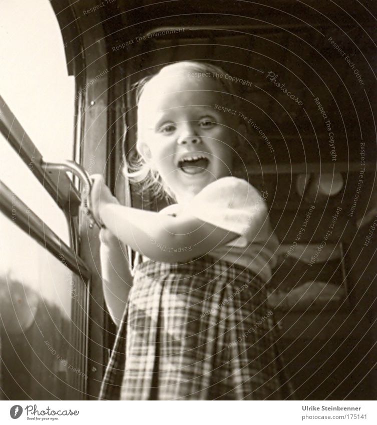 Little laughing girl standing at the open train window Black & white photo Interior shot Day Upper body Looking into the camera Human being Child Girl 1