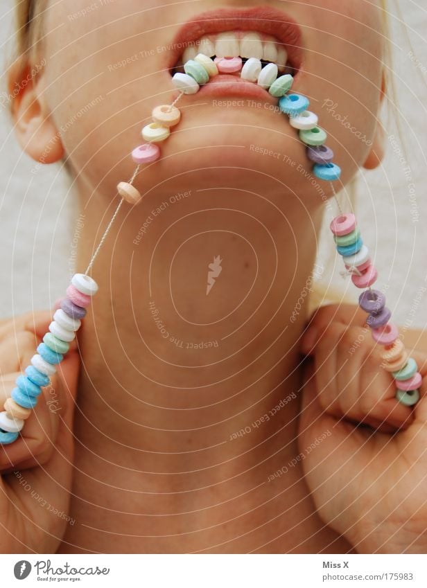 sweet anger Colour photo Multicoloured Close-up Detail Neutral Background Forward Food Candy Nutrition Eating Fairs & Carnivals Human being Feminine Young woman