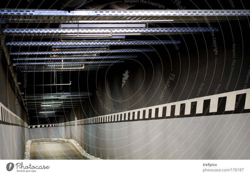 tunnel vision Colour photo Interior shot Artificial light Long exposure Deserted Parking garage Wall (barrier) Wall (building) Concrete Gloomy Town Gray Black