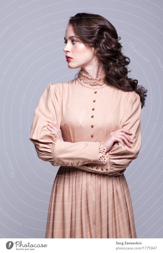 Portrait of young beautiful woman in retro beige dress Elegant Style Beautiful Skin Face Manicure Make-up Girl Woman Adults Hand Fashion Dress Brunette Thin