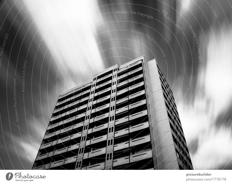 skyscraper Living or residing House (Residential Structure) Sky Clouds Weather Wind Town Deserted High-rise Facade Concrete To hold on Flying Strong Black White