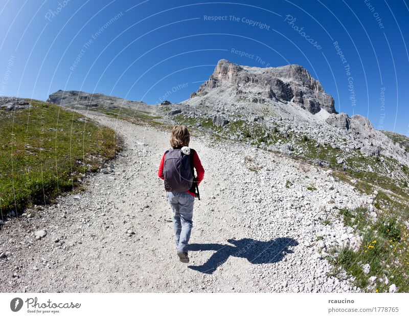 Young hiker walking on a mountain trail. Dolomities, Italy Joy Vacation & Travel Tourism Adventure Summer Mountain Sports Child Boy (child) Man Adults Nature