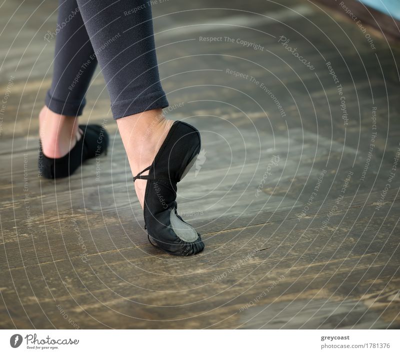Ballerinas legs in black pointes on wooden floor in point position Elegant Style Beautiful Dance School Profession Girl Woman Adults Feet Dancer Ballet Footwear
