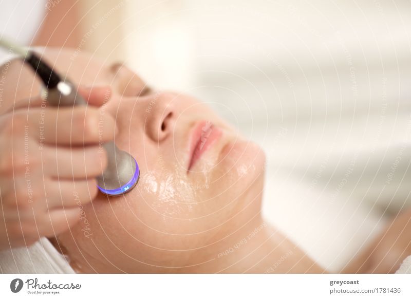 Close-up shot of woman getting professional facial treatment with special equipment. Cosmetician doing lifting procedure Skin Face Health care Medical treatment