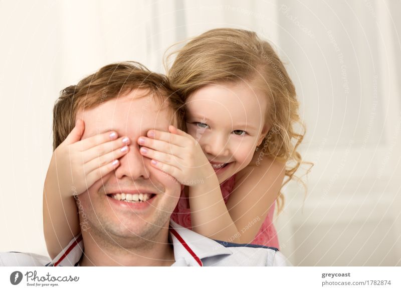 Father and daughter playing at home. Little girl closing dads eyes with hands and laughing. Family fun together Joy Happy Playing Child Human being Girl