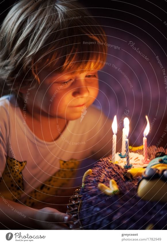 Little boy blows out candles in the cake for his 4th birthday Dessert Joy Happy Face Decoration Feasts & Celebrations Birthday Child Human being Boy (child)