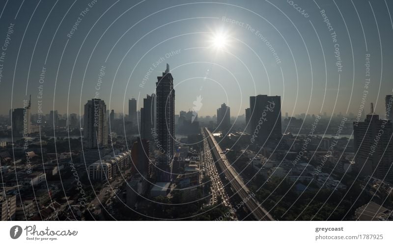 Cityscape of Bangkok, Thailand. Bright morning sun shining over the metropolis with high-rise buildings and traffic on motorway Sun Town High-rise Building