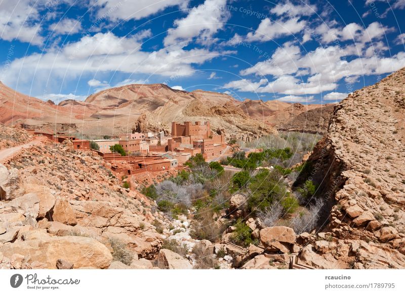 Ancient Kasbah in Dades Valley, south Morocco, Africa. Vacation & Travel Summer Mountain Landscape Sky Clouds Tree Oasis Village Stone Blue Yellow Green Red