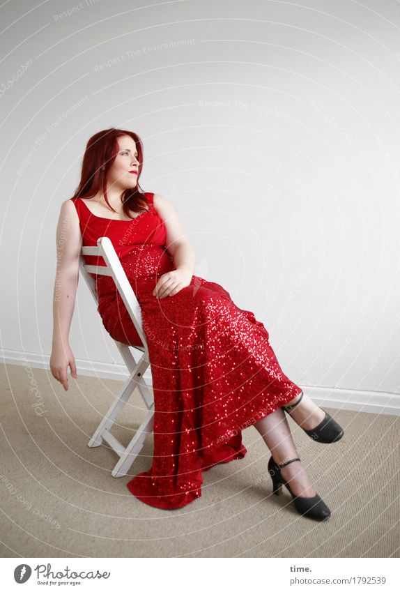 . Chair Room Feminine 1 Human being Dress Red-haired Long-haired Observe Looking Sit Elegant Beautiful Contentment Self-confident Caution Serene Patient Calm