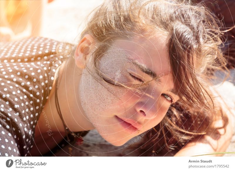 Young woman lies on the beach with sand in her face Lifestyle Joy Sand already Face Relaxation Calm Vacation & Travel Tourism Summer vacation Beach Human being