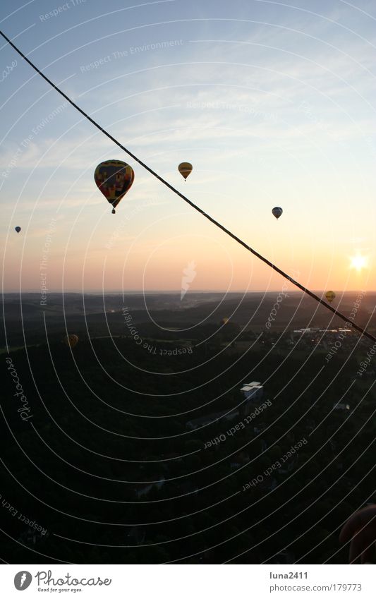 balloon ride Colour photo Exterior shot Dawn Sunrise Sunset Back-light Panorama (View) Landscape Sky Beautiful weather Field Small Town Hot Air Balloon Driving