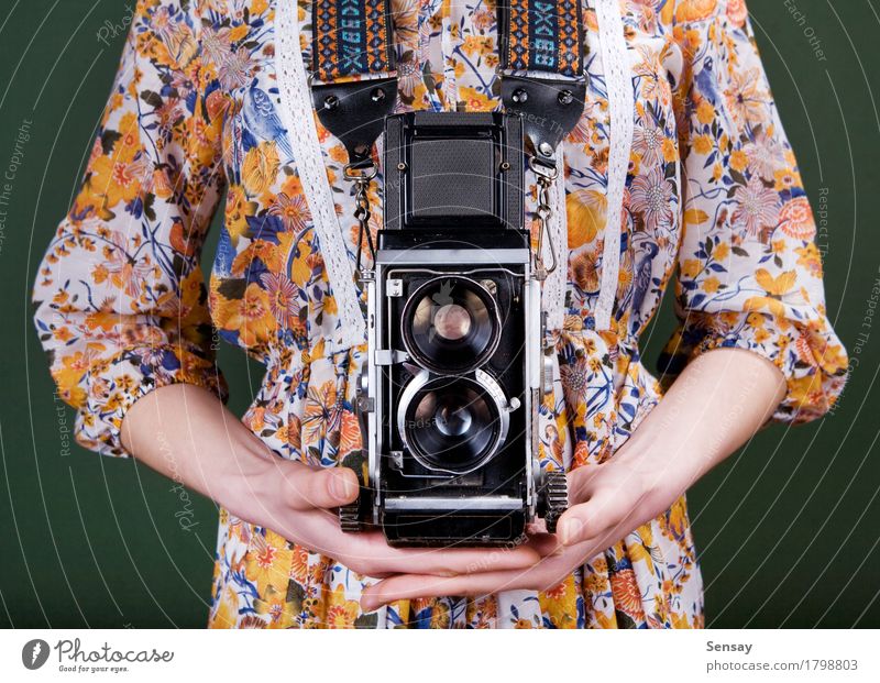 Vintage camera in hand on green Style Beautiful Camera Human being Girl Woman Adults Hand Flower Fashion Dress Old Retro Green Red White Colour vintage