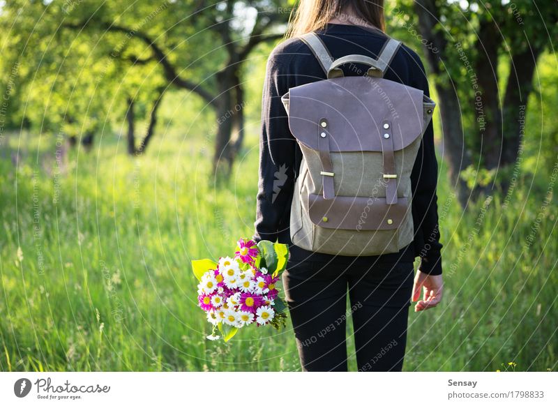 Woman hiking with backpack and flowers in hand Happy Beautiful Trip Summer Sun Hiking School Human being Girl Adults Youth (Young adults) Nature Flower Park